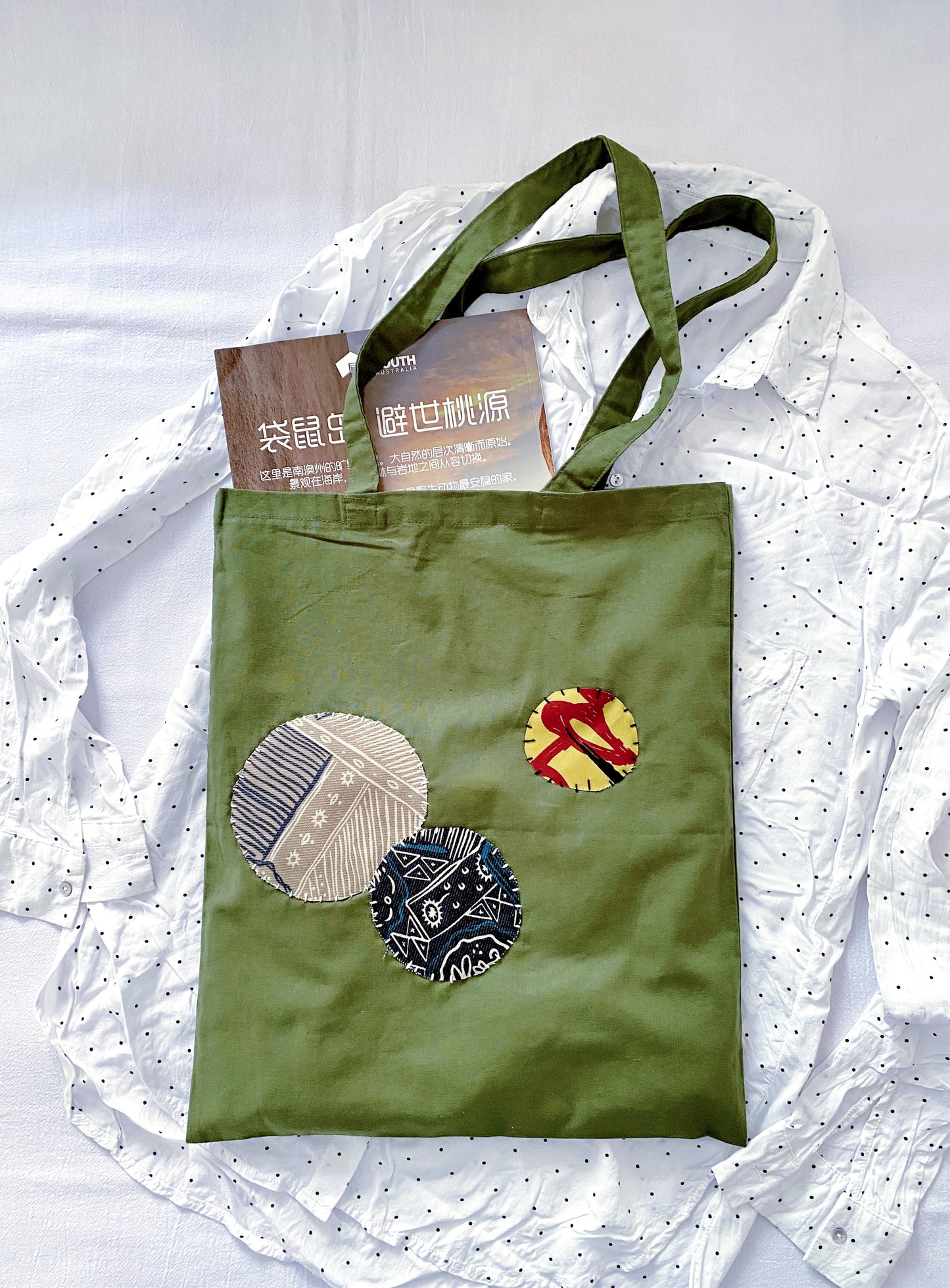 Close-up of unique patchwork stitching on a soft foldable sustainable fabric bag