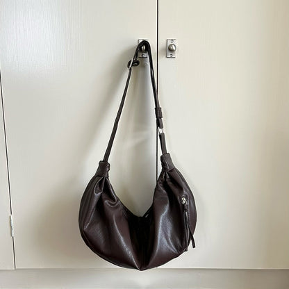 Curved handbag for carrying essentials around town.