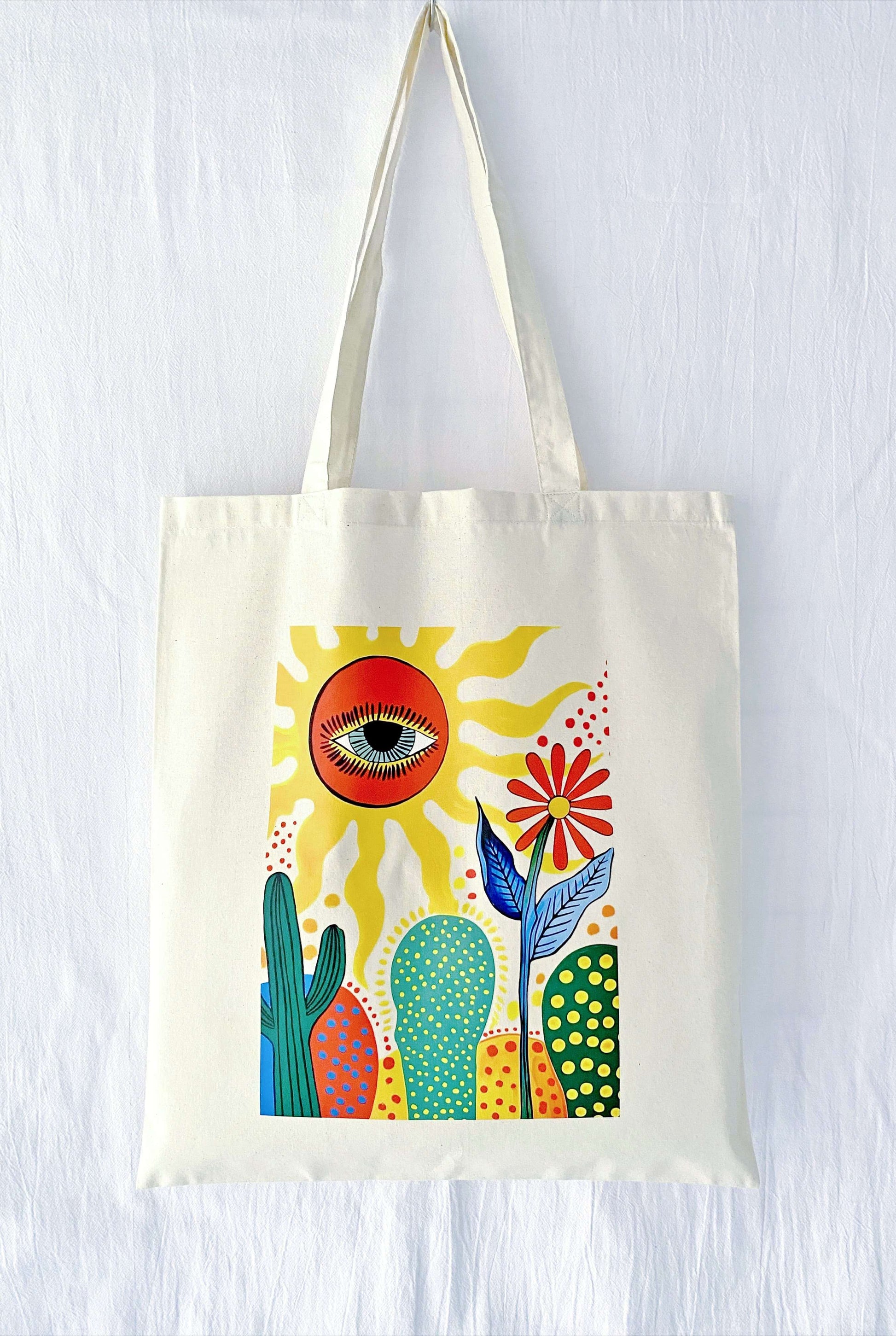 A stack of three different hand-printed totes, suggesting a thoughtful matching gift set for bridesmaids or a group of close sisters.