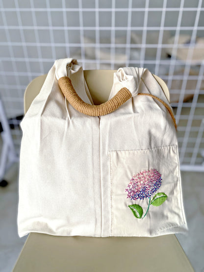Durable floral embroidered canvas tote for everyday essentials and gifts.