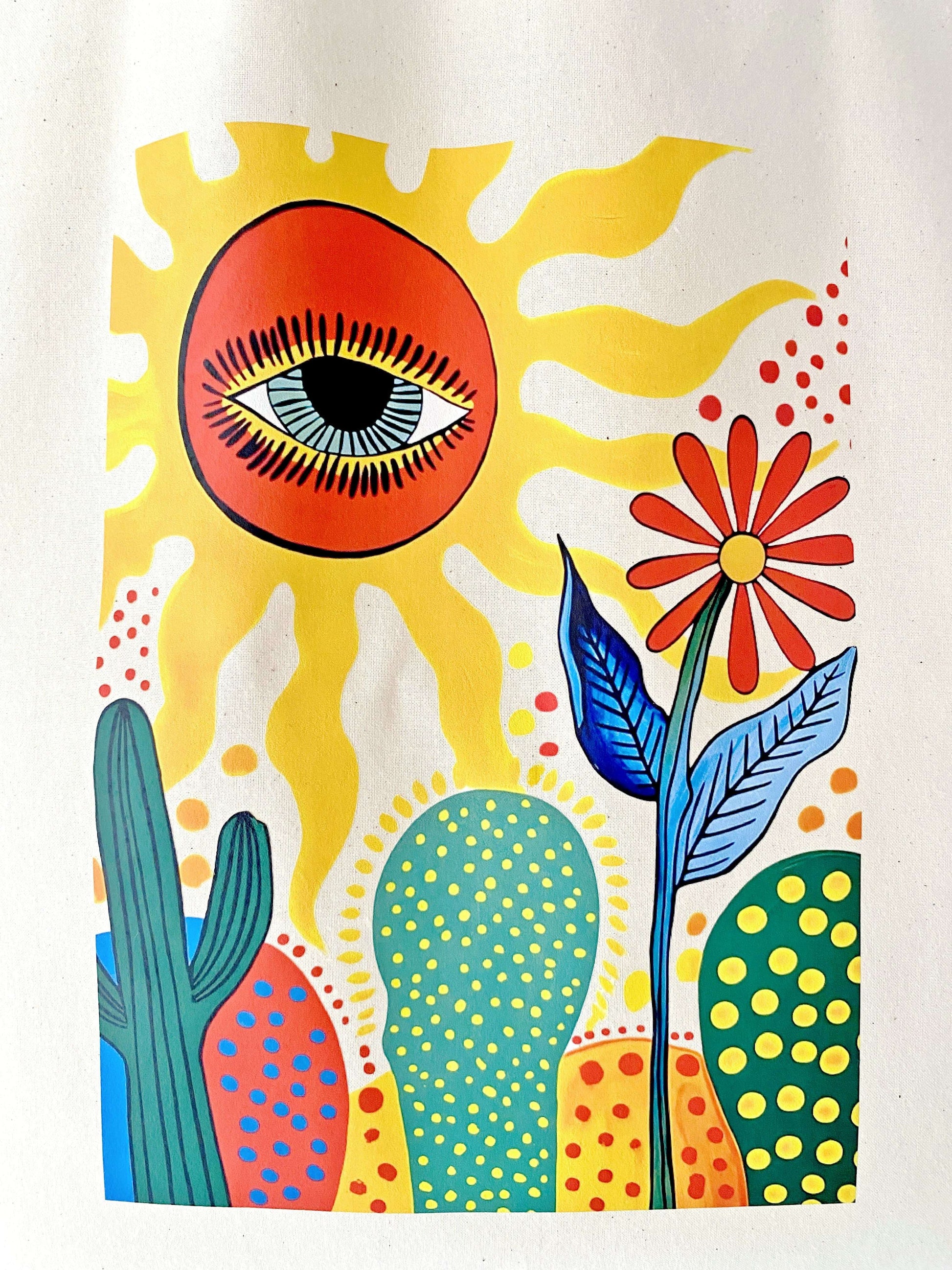 Sun and cactus art printed on a large, breathable natural fiber shoulder bag.