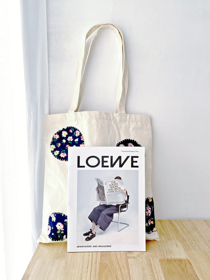 Lifestyle action shot: a commuter effortlessly carrying the ultralight patchwork tote through a busy urban subway station.