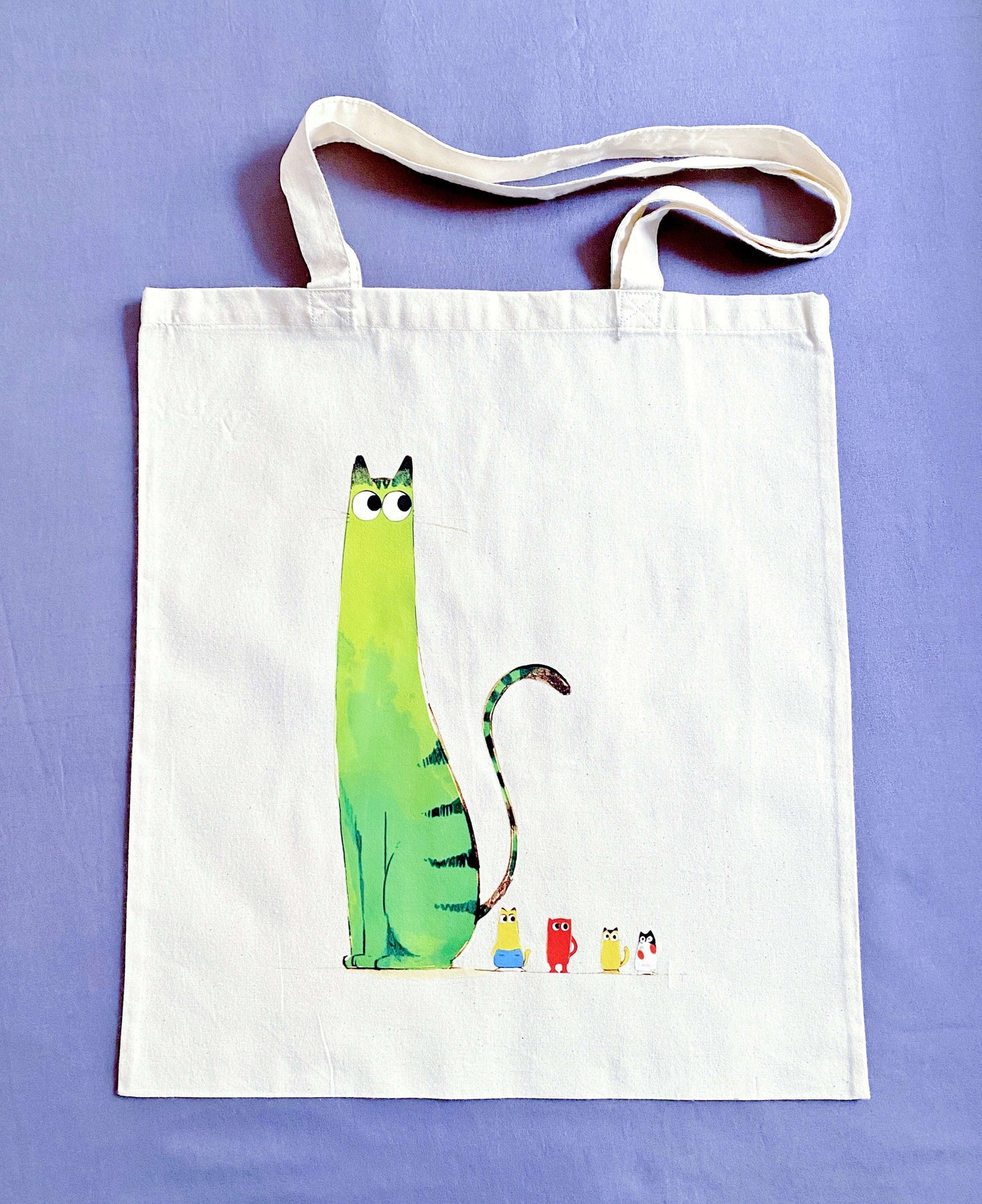 A soft cotton tote with a hand-printed kitty, the kind of bag people reach for when they want something easy, light, and quietly cheerful.