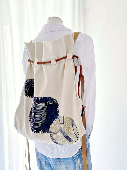 Minimalist outfit paired with creative patchwork backpack