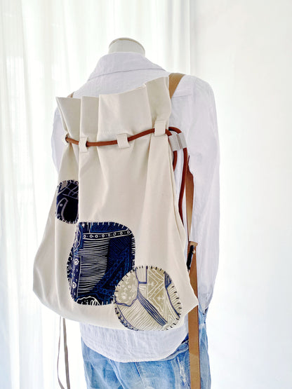 Minimalist outfit paired with creative patchwork backpack