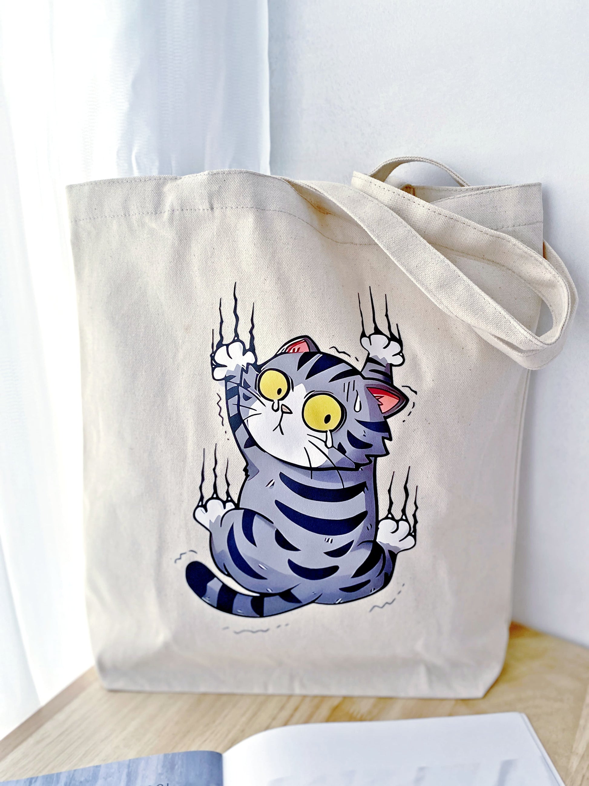 Large durable tote holding fresh groceries and flowers on a park bench