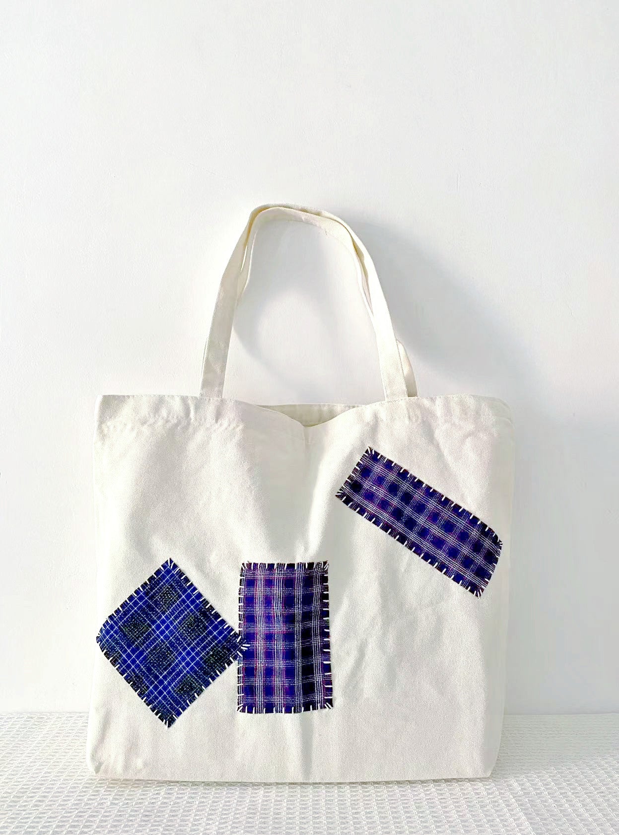 relaxed bag with a jacket draped over it at home