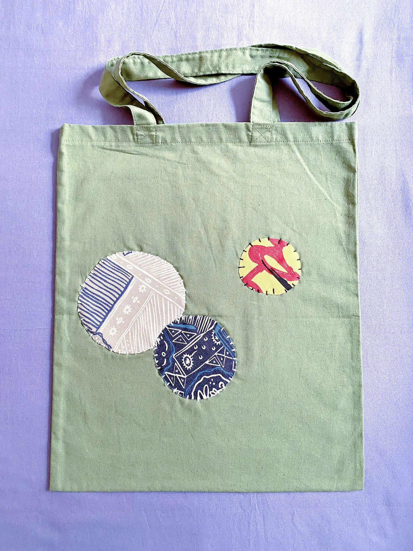 Ultra-soft olive cotton tote with hand-stitched details, feels like a warm hug on a busy day.