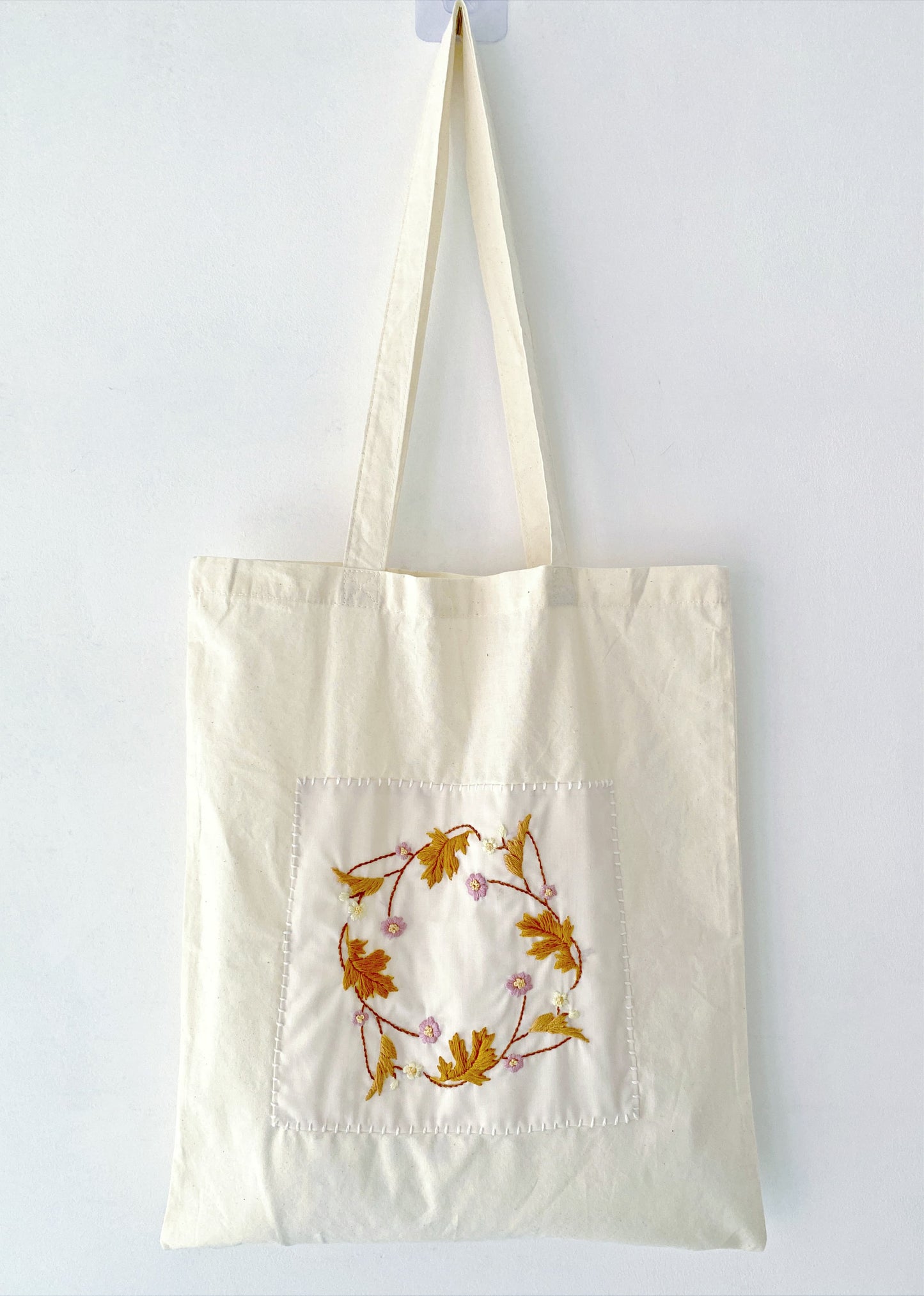 Sustainable shopping bag promoting individuality through DIY handcrafted flower embroidery.