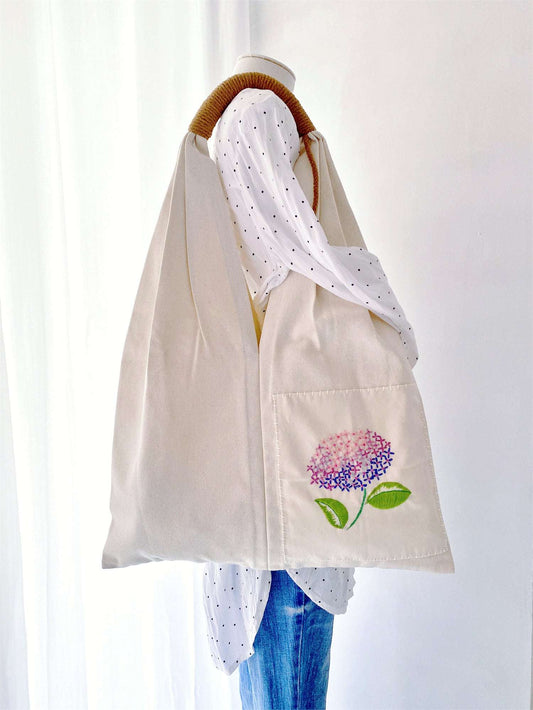 Carry your essentials with this unique hand-embroidered floral tote bag, made from eco-conscious cotton canvas. Ideal for those who care about style and the planet.