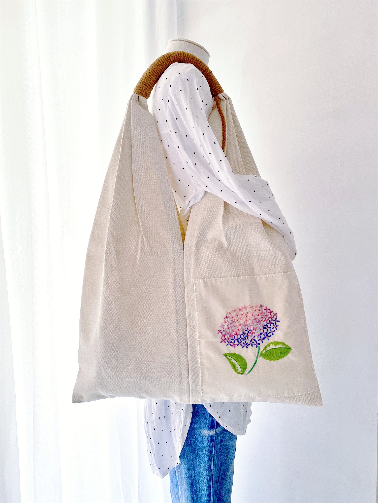 Carry your essentials with this unique hand-embroidered floral tote bag, made from eco-conscious cotton canvas. Ideal for those who care about style and the planet.