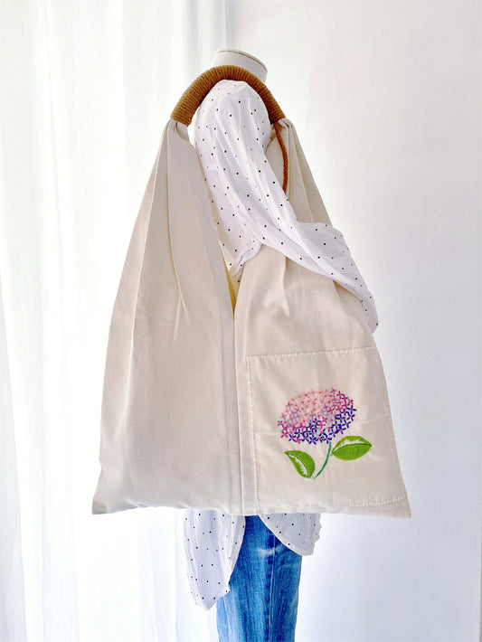 Carry your essentials with this unique hand-embroidered floral tote bag, made from eco-conscious cotton canvas. Ideal for those who care about style and the planet.