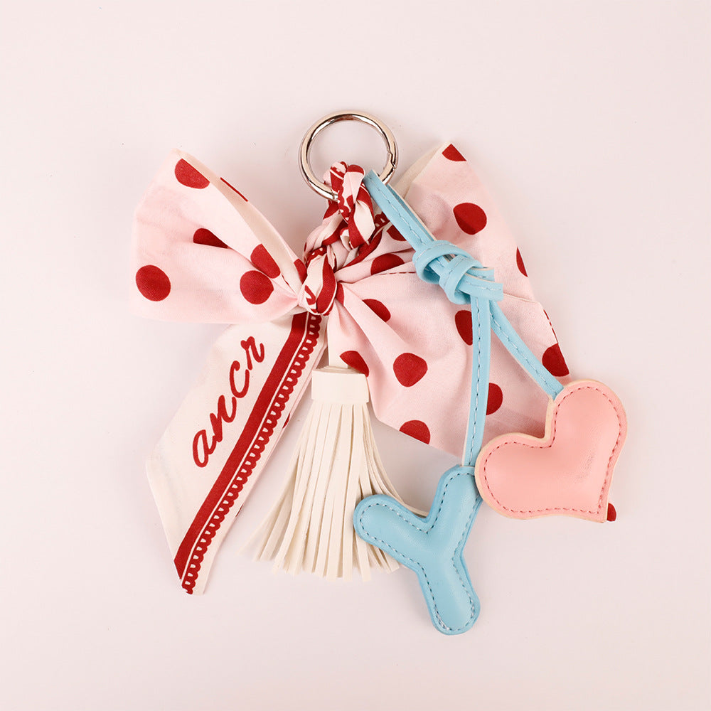 Pink bow accessory for personalizing a leather handbag