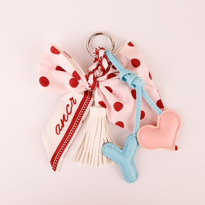 Pink bow accessory for personalizing a leather handbag