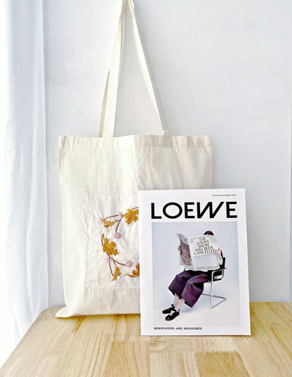 Stylish cotton tote appealing to those who love literary and handmade-look accessories.