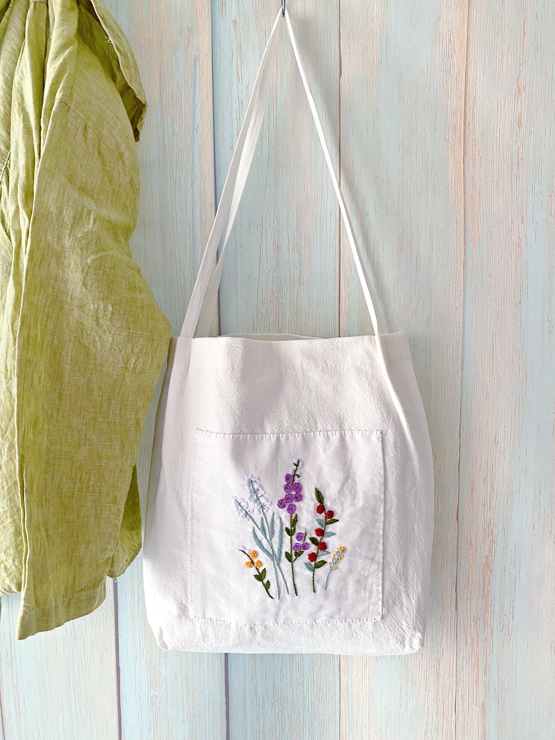Hand embroidered botanical canvas shoulder bag as a thank you gesture for host