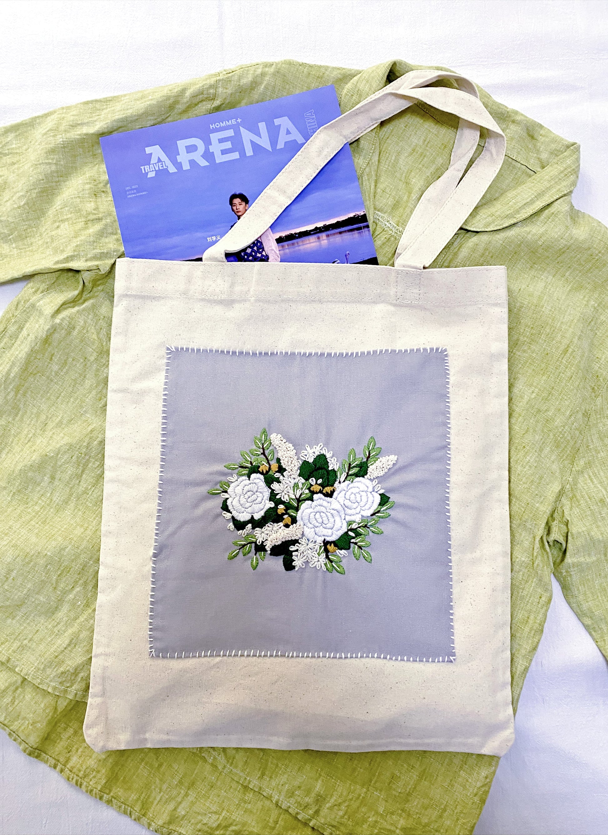 A spacious tote bag featuring an embroidered botanical motif for someone who values human touch over mass production.