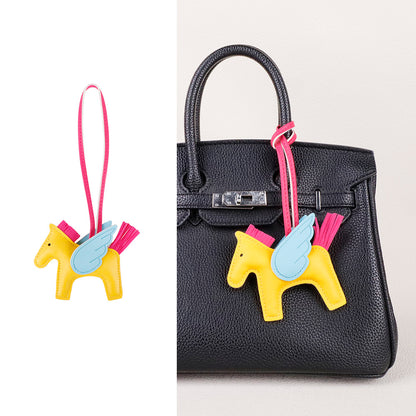 Detailed shot of a hand-assembled horse bag pendant showcasing premium edge painting