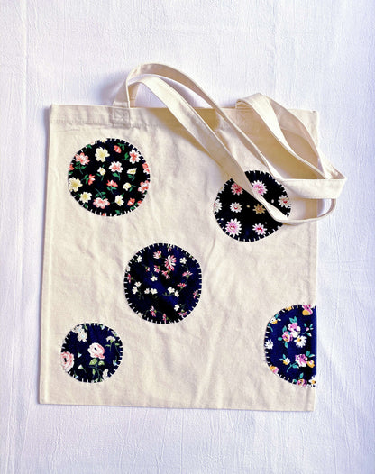 Thoughtful sustainable gift idea featuring distinct hand-sewn patchwork patterns on a reusable heavy-duty tote.