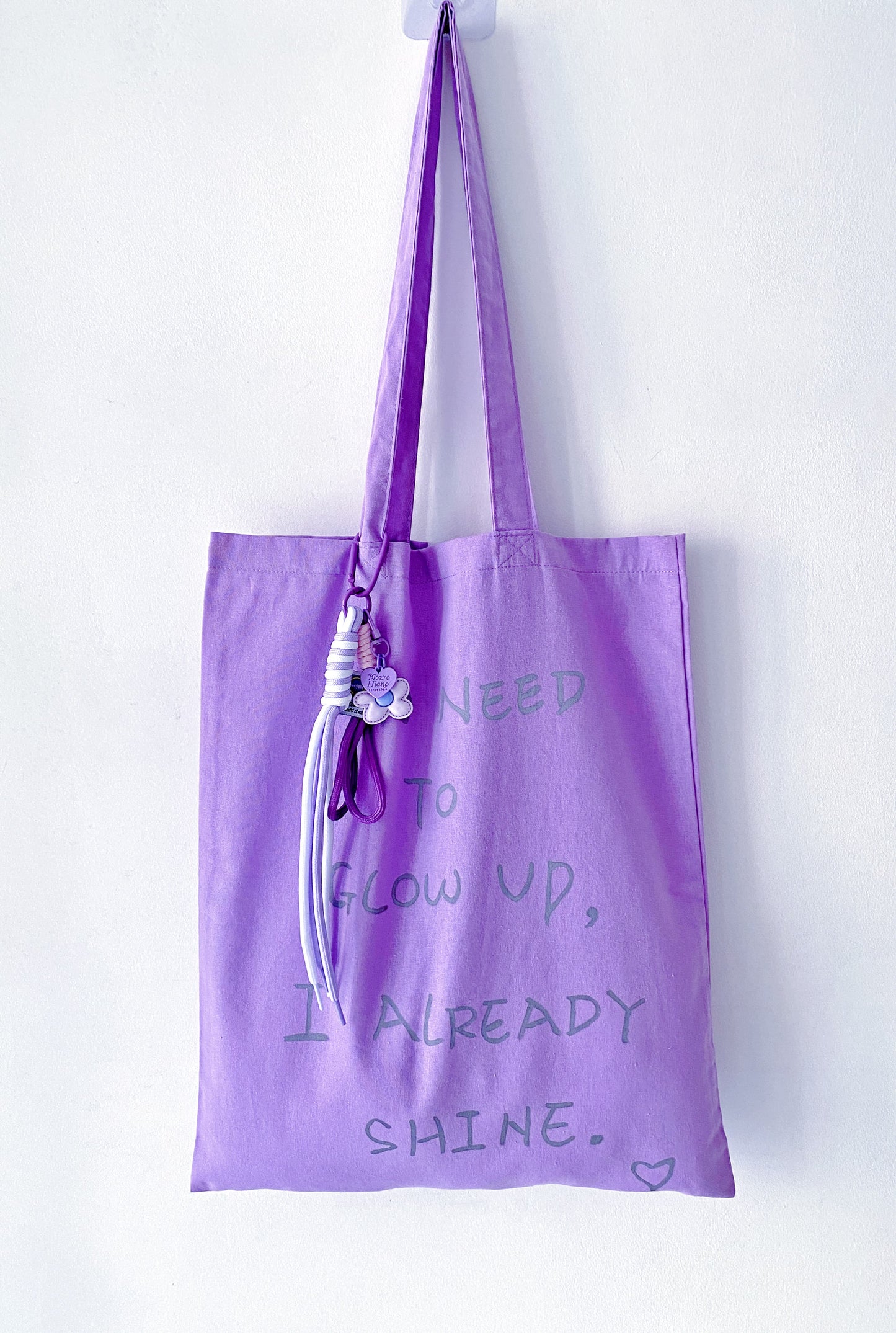 fabric tote bag hanging loosely on a door handle at home