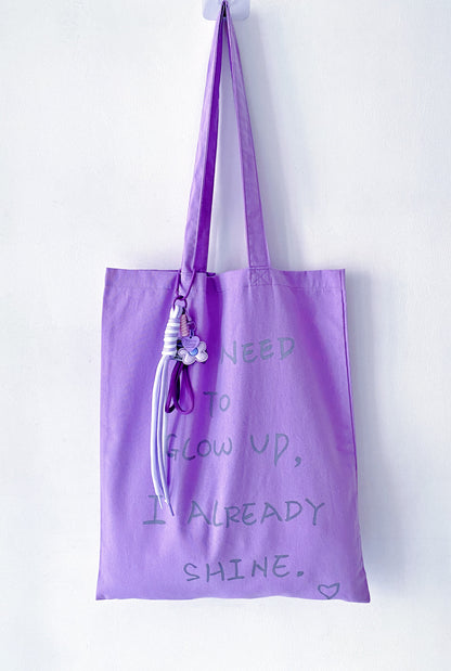 fabric tote bag hanging loosely on a door handle at home