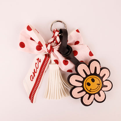 Decorative pink bow keyring with a playful polka dot pattern