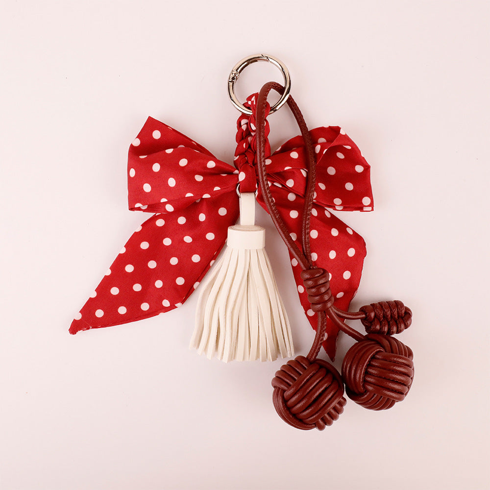 Handmade red bag charm with a spotted bow design