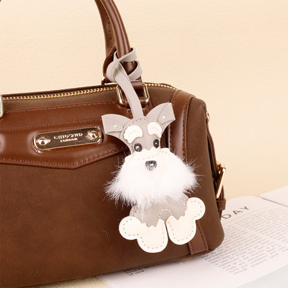 Soft plush puppy keychain featuring a Christmas Schnauzer