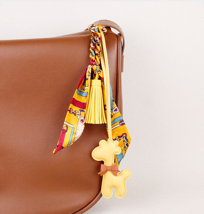Long flowing scarf and tassel beside a giraffe figure