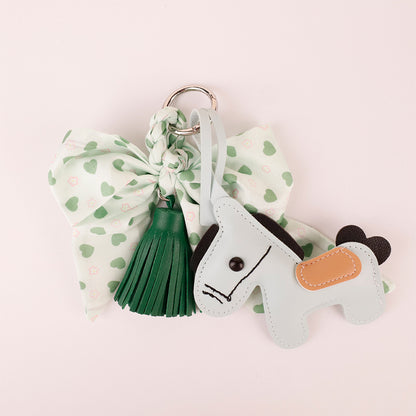 Dark green tassel and bow charm on top handle everyday bag