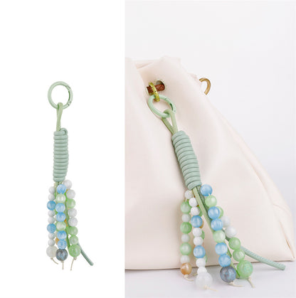 Natural bead and tassel accessory for a women's handbag
