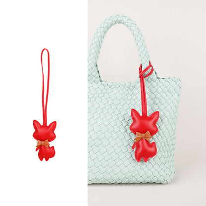 Small handmade accessory hanging from a car interior hook