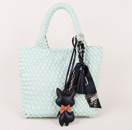 Small fox accessory with a flowing scarf and tassel detail