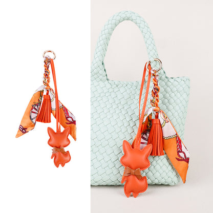 Handmade charm attached to a compact crossbody bag