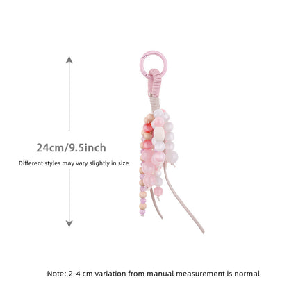 Pink jade charm adding detail to a simple shoulder bag