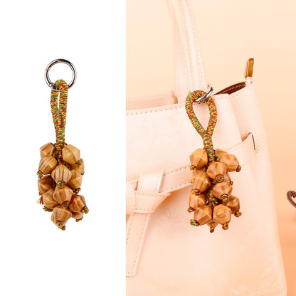 Fruit cluster ornament styled with a crossbody bag