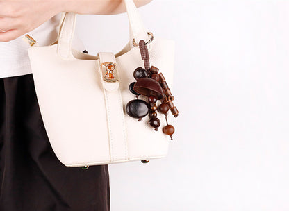 Woven style bag charm made with natural shell beads