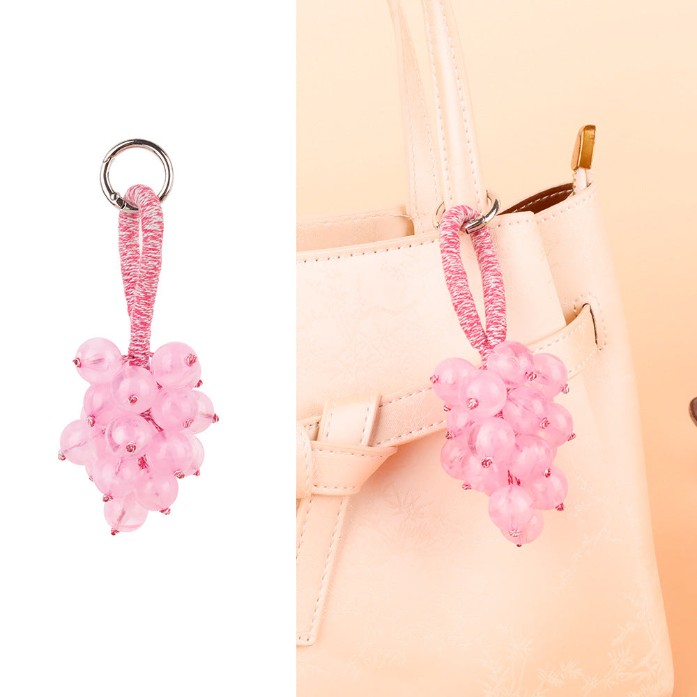 Small bell ornament swinging from a bag strap