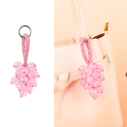 Small bell ornament swinging from a bag strap