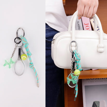 Green charm accessory paired with a relaxed weekend tote
