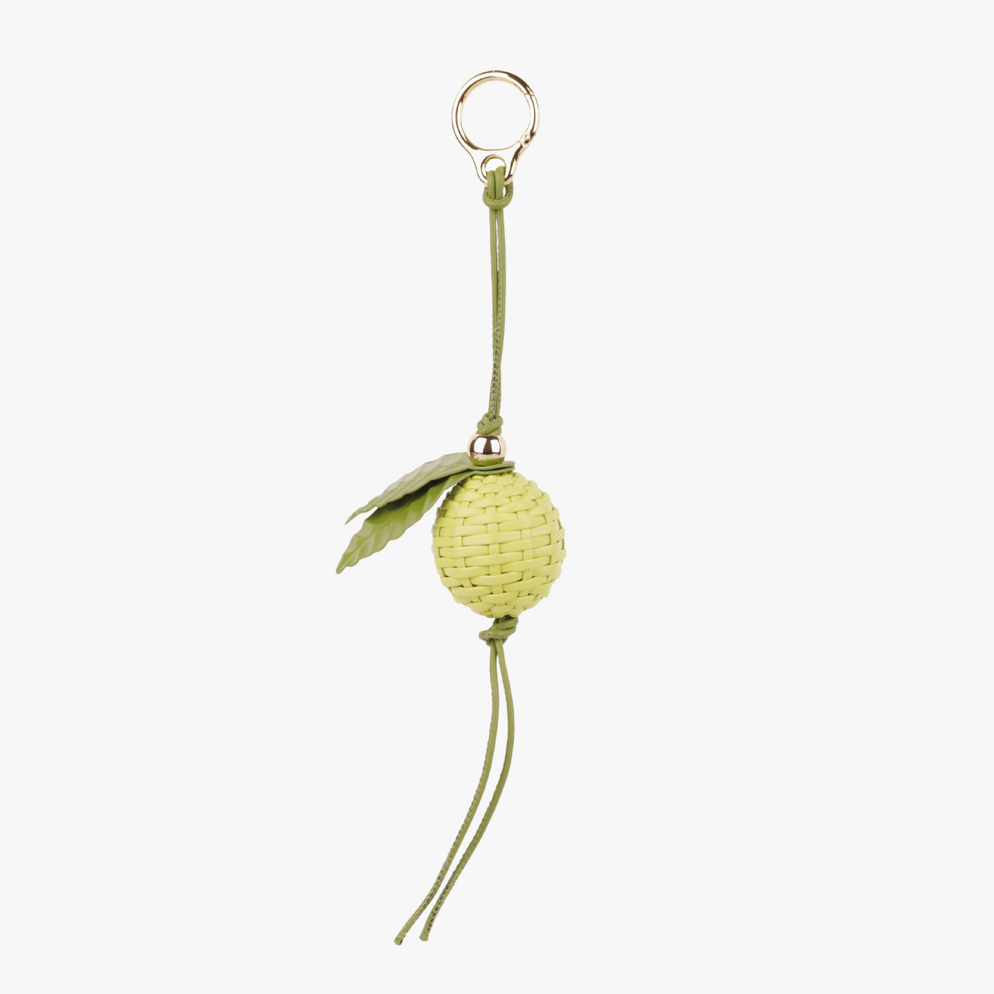 Fresh lime green leaf charm hanging from a handbag