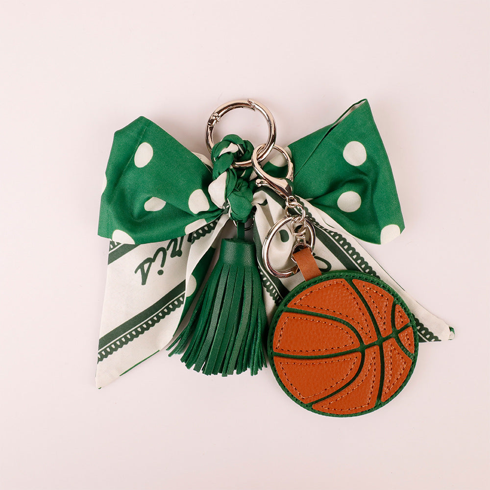 Earthy forest green bow charm styling on a minimalist tote bag