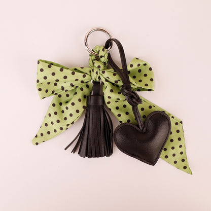 Green tassel scarf key holder attached to travel weekender bag