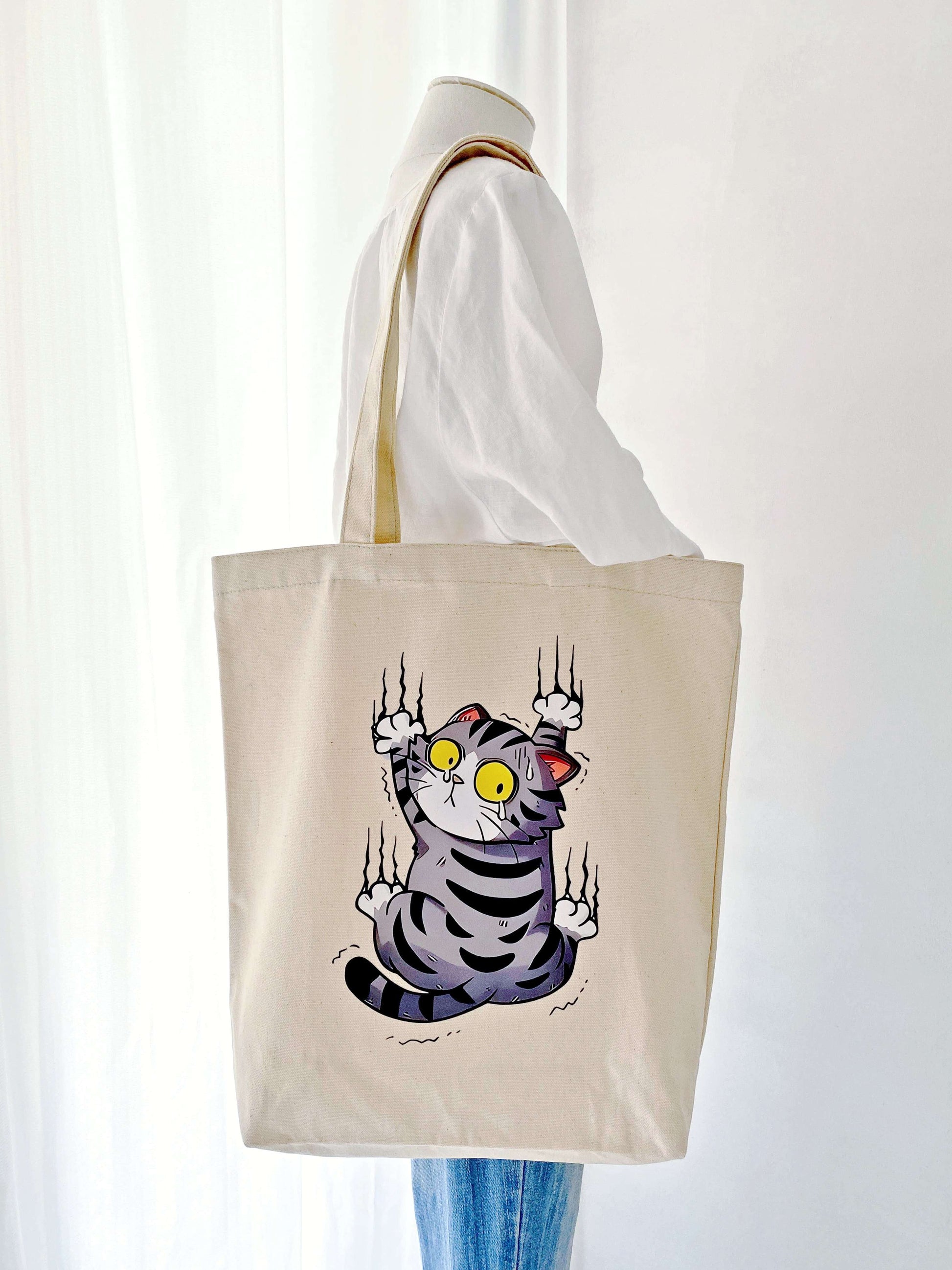 durable everyday tote bag featuring a surprised cat design