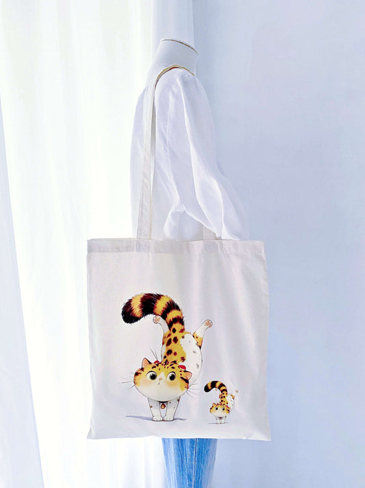 This eco-friendly tote with a hand-printed orange cat makes a thoughtful gift for anyone who loves both style and sustainability.