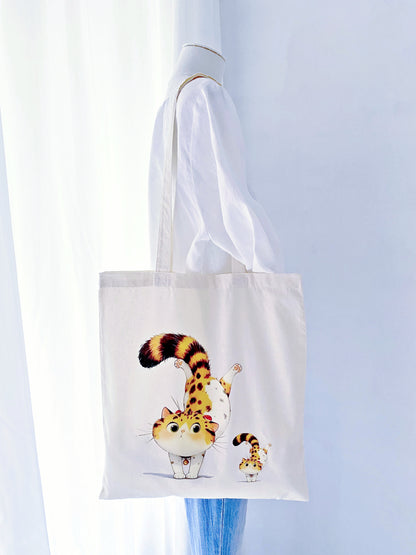 This eco-friendly tote with a hand-printed orange cat makes a thoughtful gift for anyone who loves both style and sustainability.