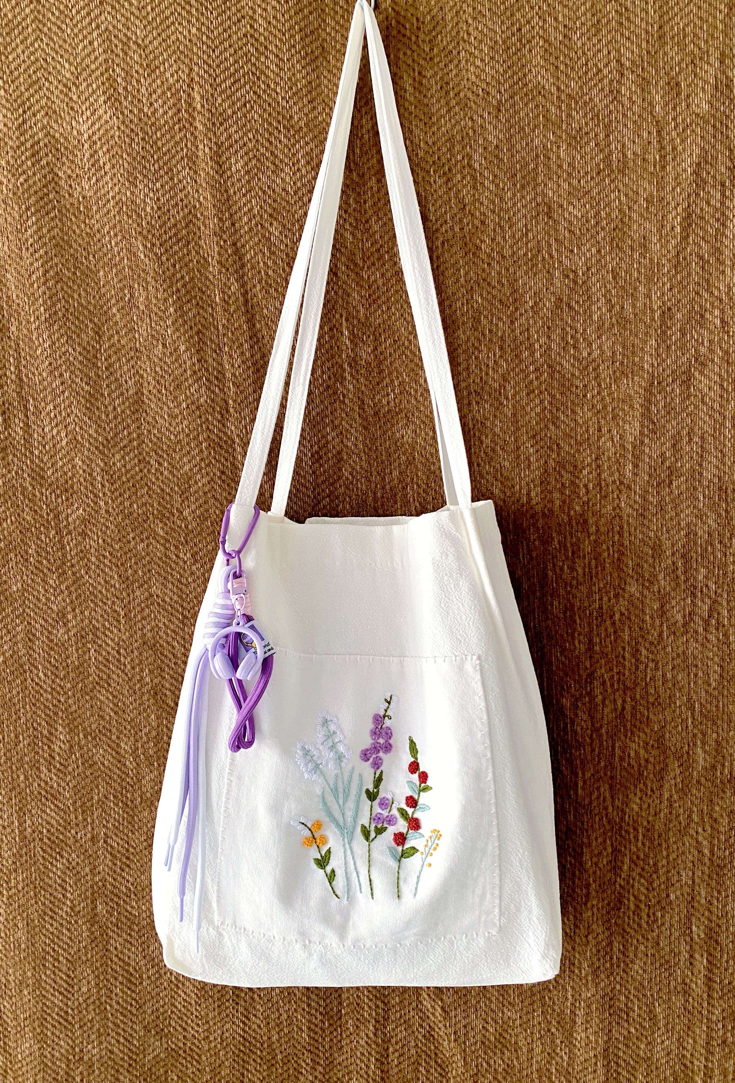 Thoughtful gift for her featuring a hand-embroidered floral linen bag symbolizing slow beauty.