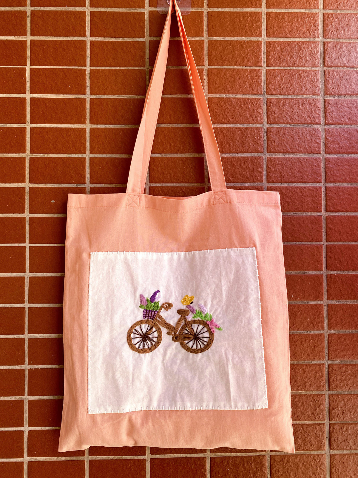 Hand-embroidered orange cotton tote selected as a present for an art lover