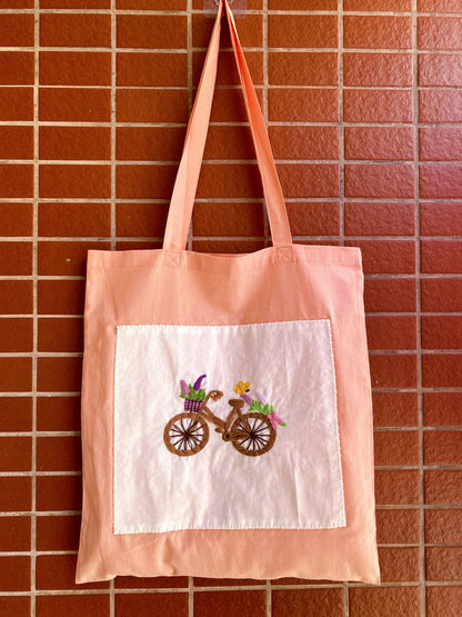 Hand-embroidered orange cotton tote selected as a present for an art lover
