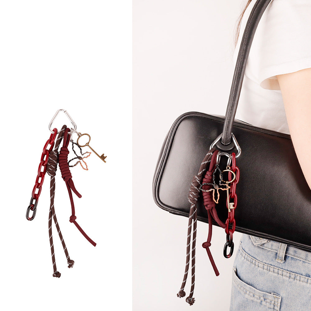 Handcrafted rope key pendant shown on a neutral canvas handbag